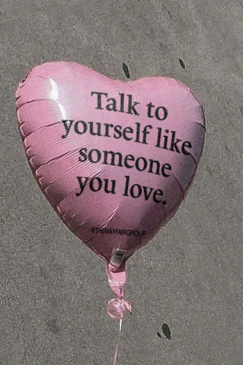 Pink heart ballon with the words: "Talk to yourself like someone you love" on the ballon
